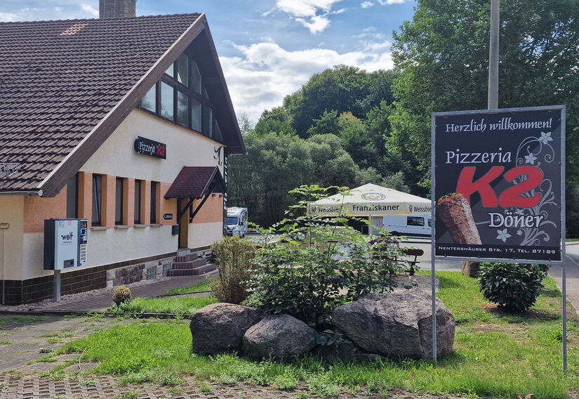Aussenbereich Pizzeria mit Werbeschild